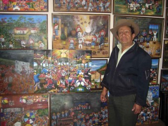 Oscar Perén with some of his paintings in his gallery