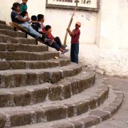 Remnants of Semana Santa decorations become the perfect vehicle for sledding down the church steps with friends. (photo: Victoria Stone)